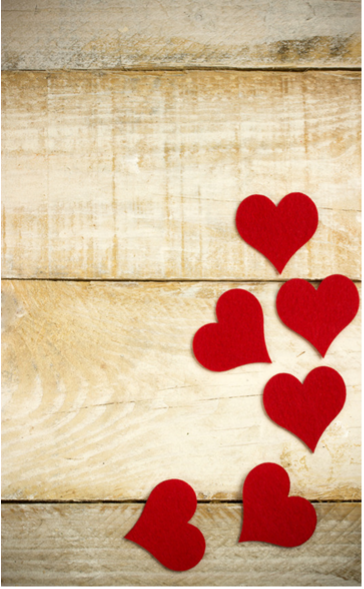Red paper cut-out hearts on a wooden surface