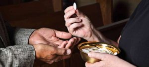 Giving communion brad to open hands