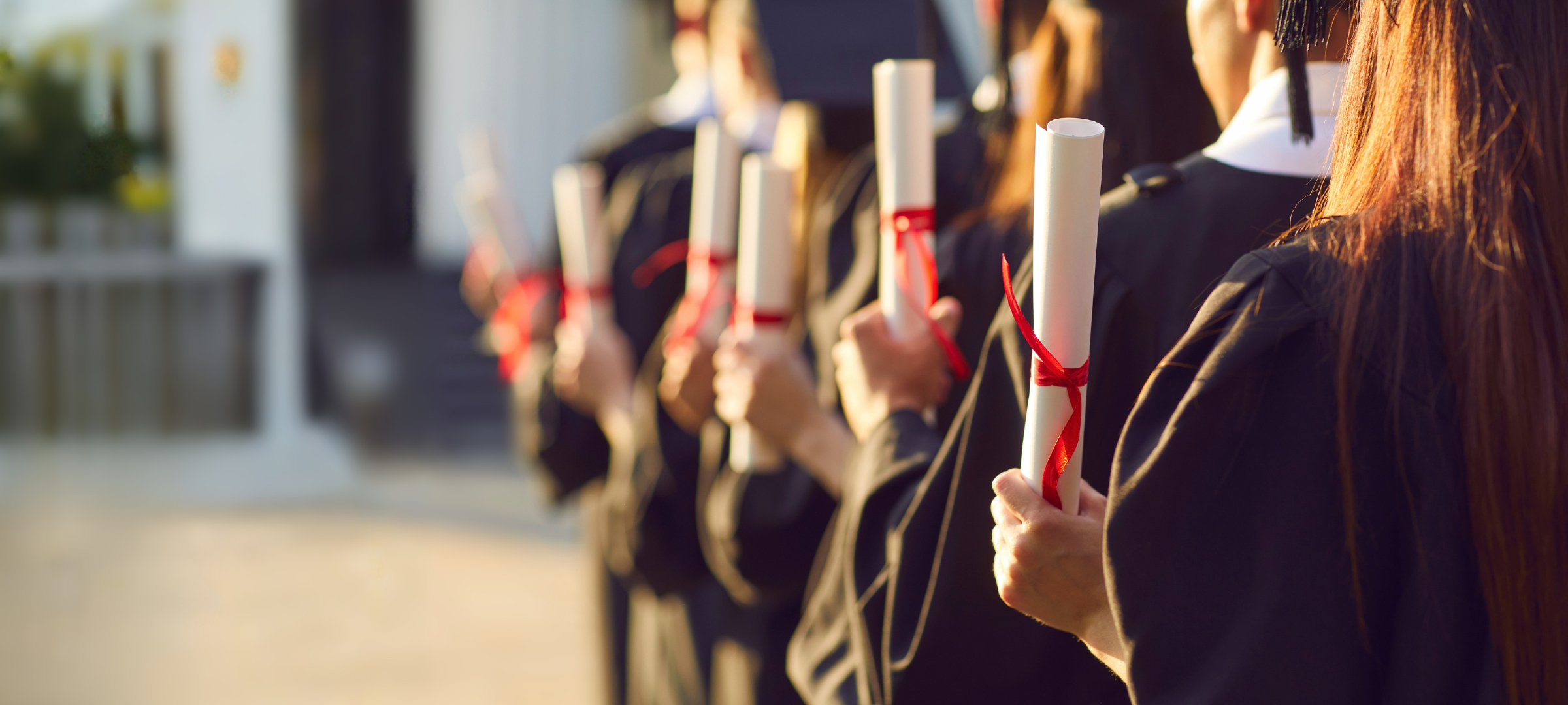 Student Award - Graduating Students holding diplomas
